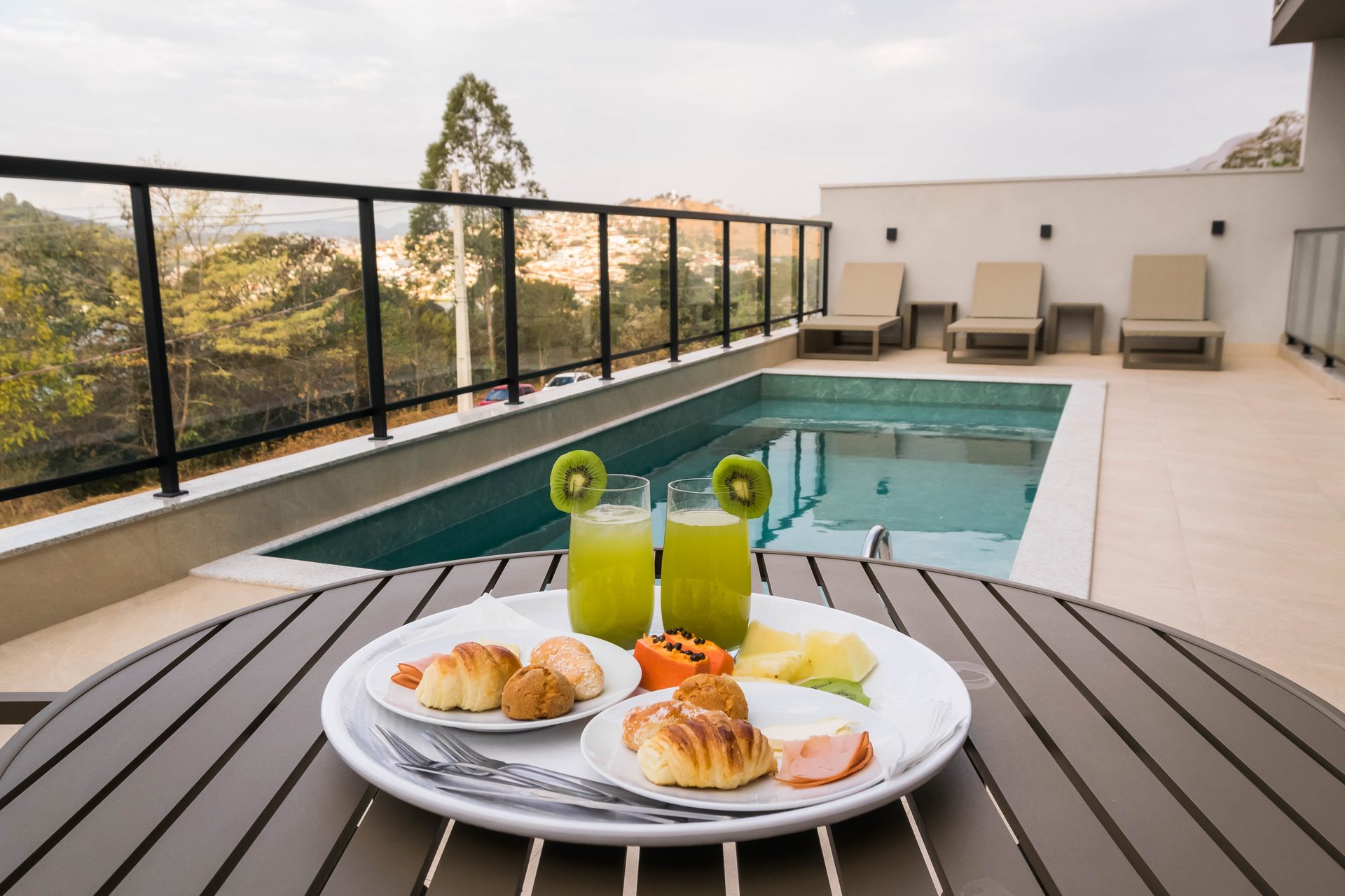 Breakfast served at a table by the pool, overlooking the mountains